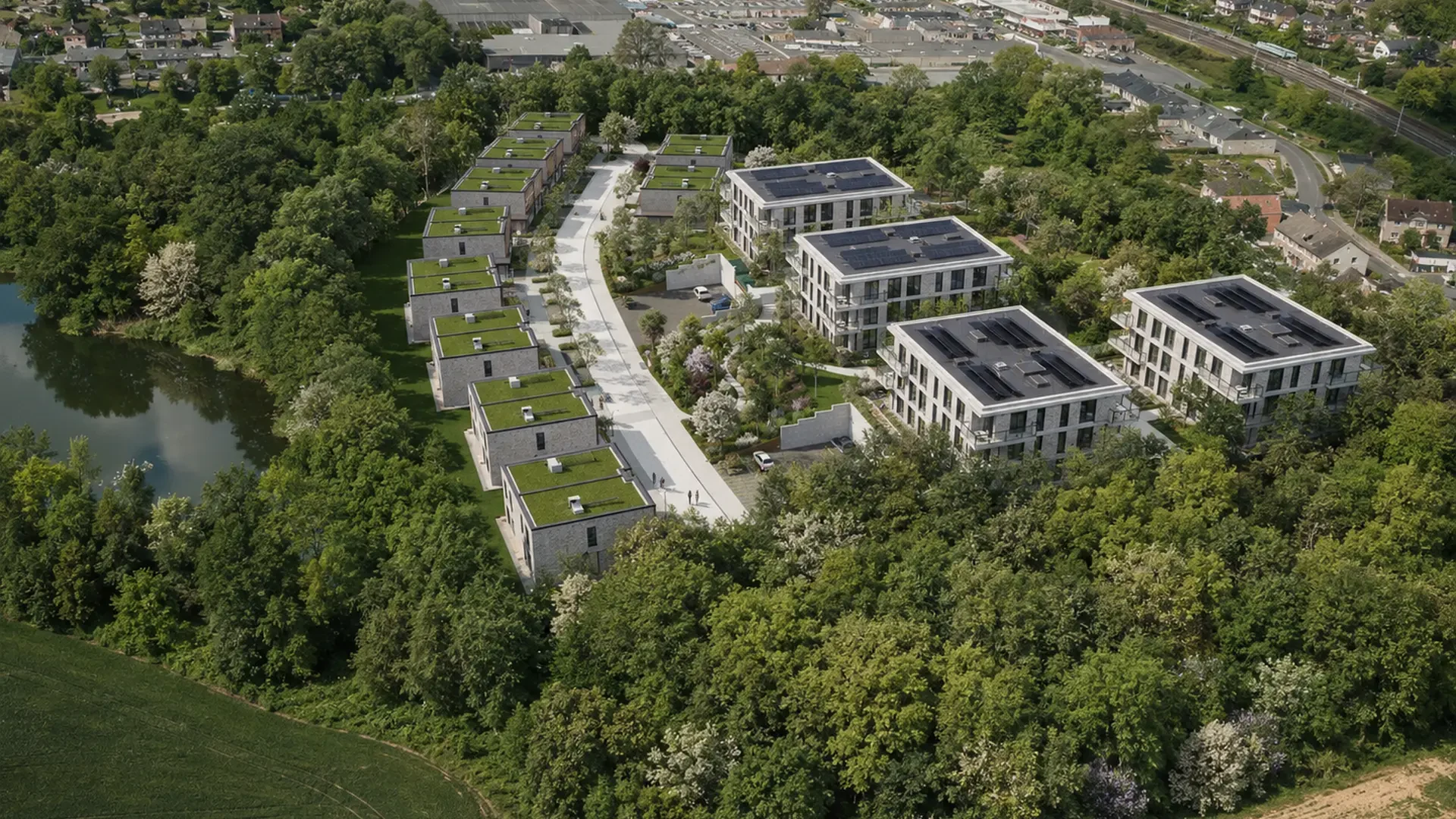 Projection aérienne des quatre immeubles et des maisons dans leur environnement arboré